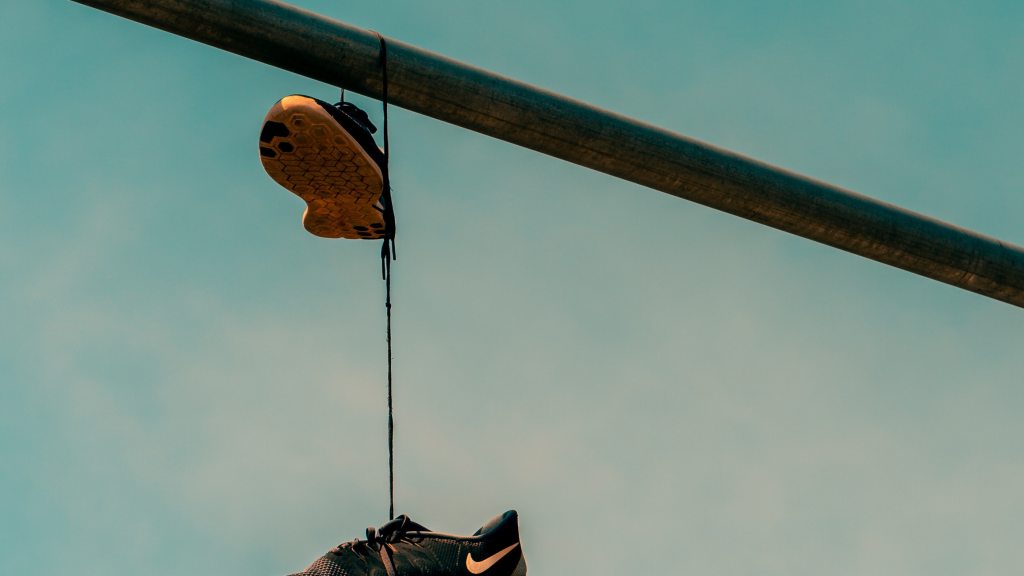 running sneakers hanging on wire